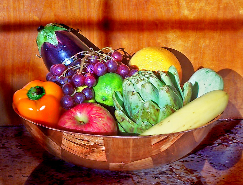 Tazón con frutas y verduras frescas ricas en fibra sobre una mesa